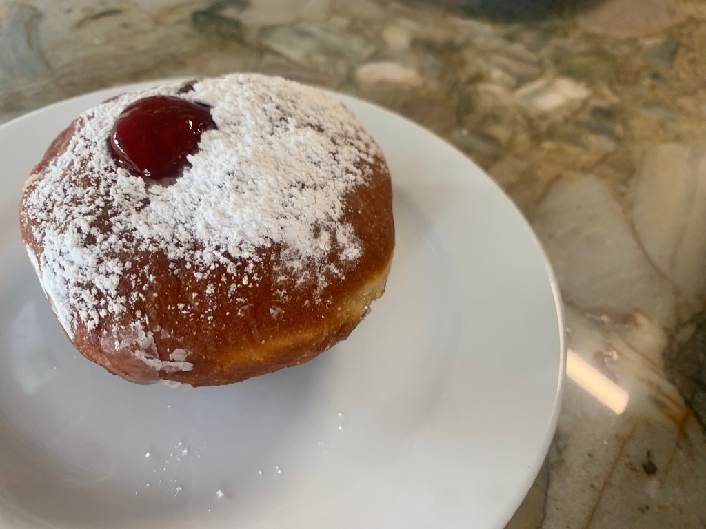 Donut with marmolada and powdered sugar
